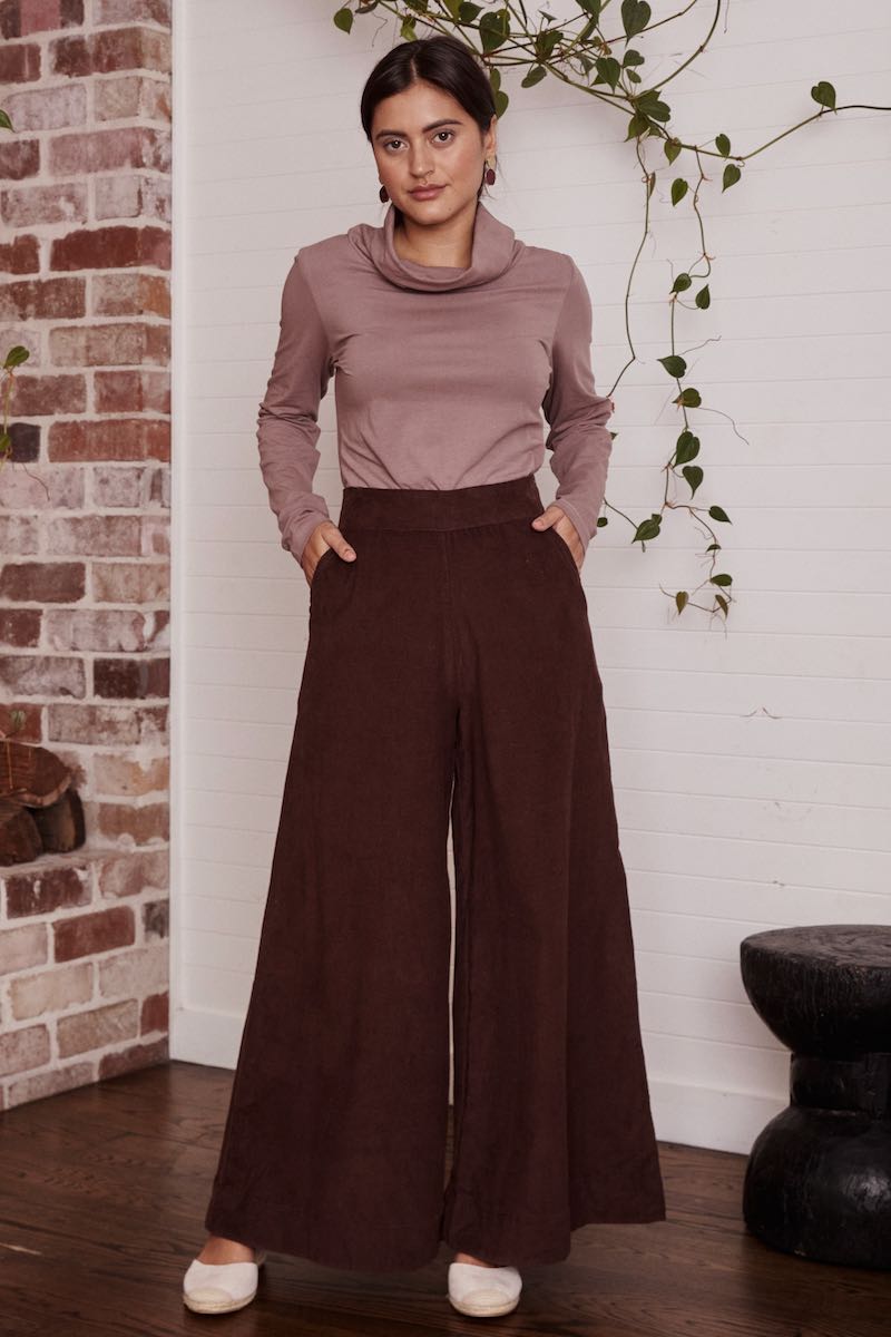 A lovely, patterned dress laid out flat, the intricate details and rich texture of the fabric on full display.