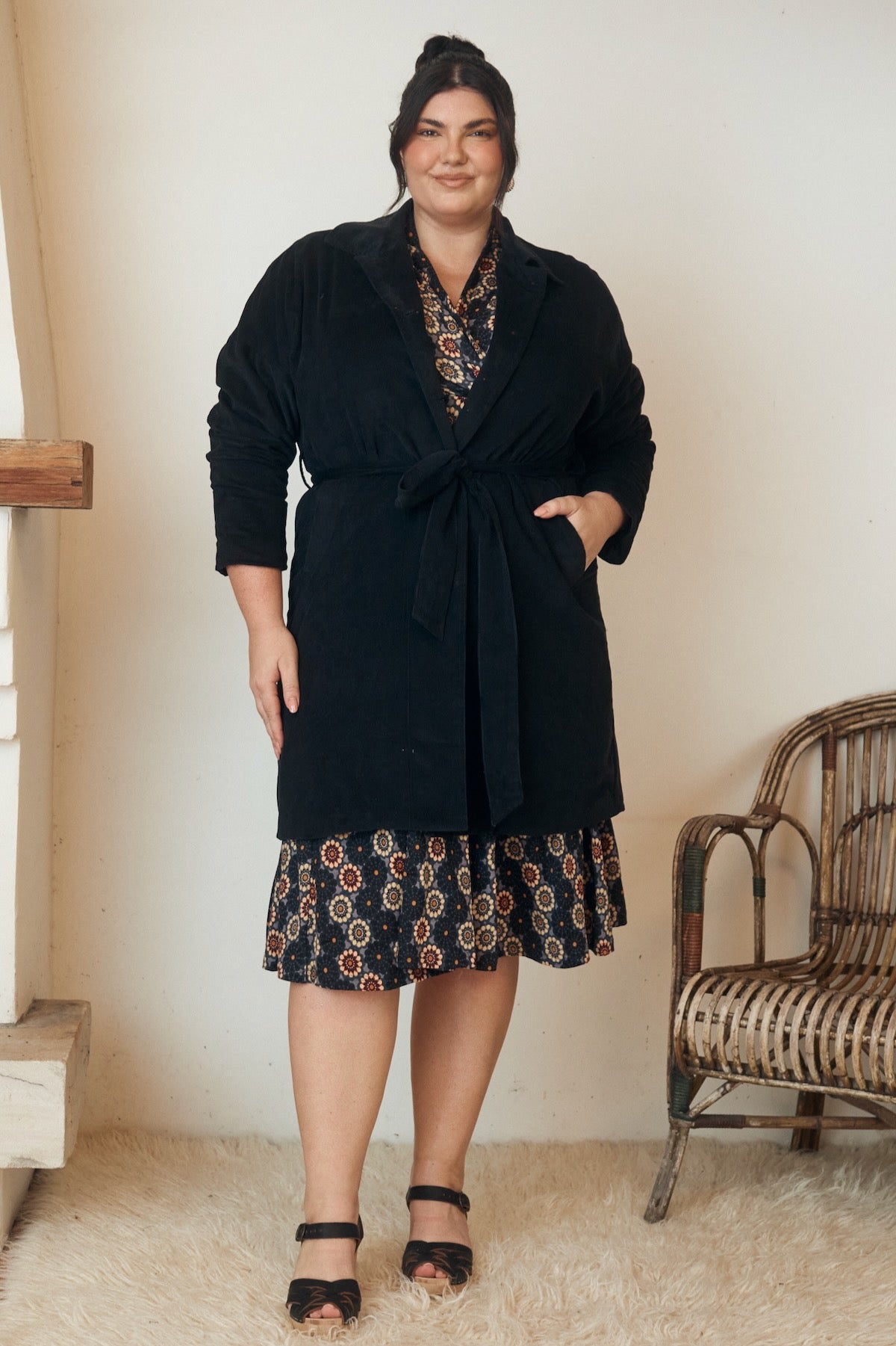 A stylish summer dress with subtle details, draped beautifully against a plain background, exuding understated elegance.