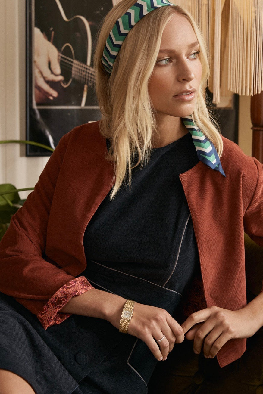 A minimalist dress displayed in soft light, with its clean lines and natural fabric evoking a sense of effortless elegance.