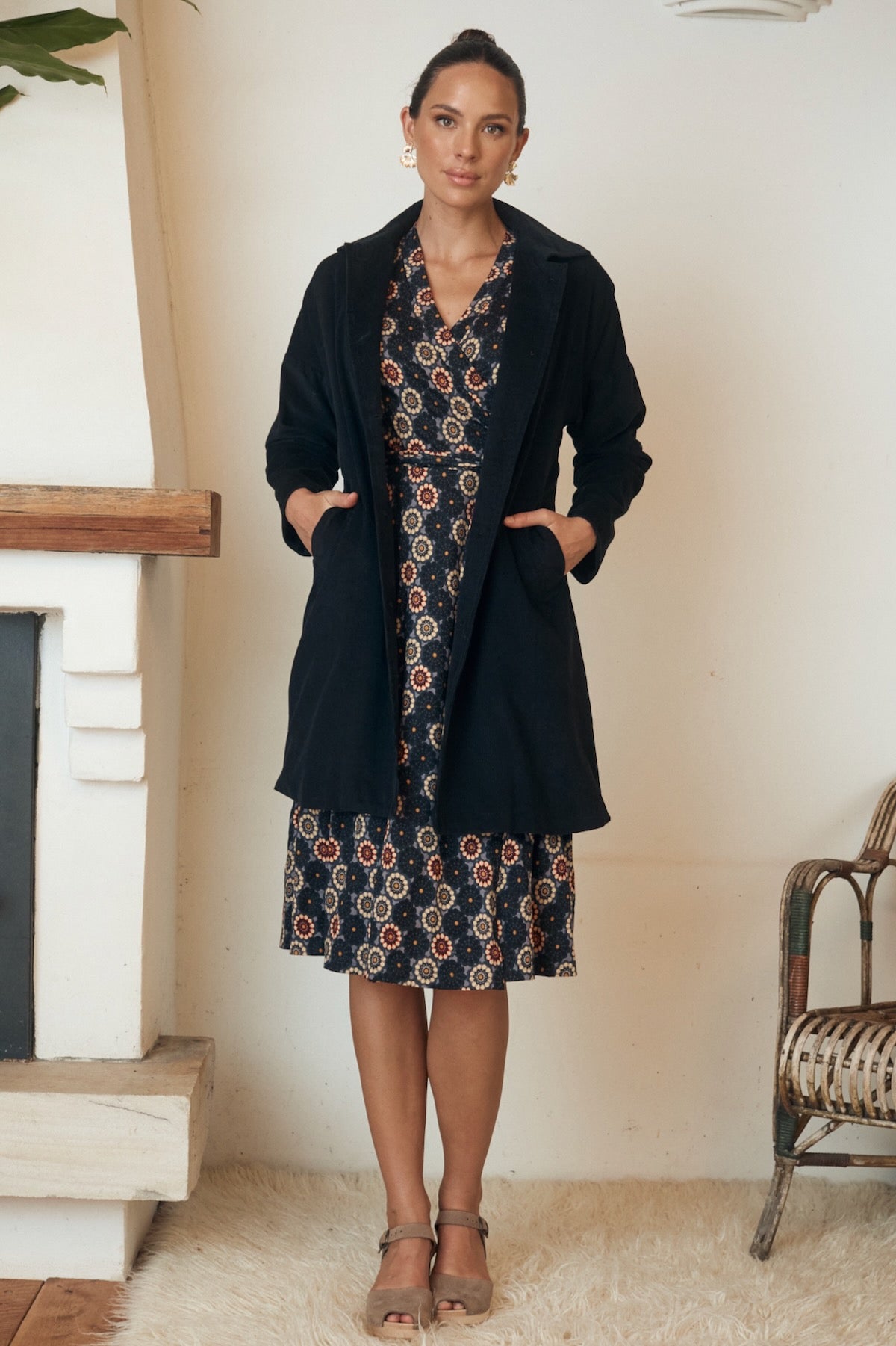 A graceful, elegant top on a hanger, its soft, organic fabric displayed against a neutral background.