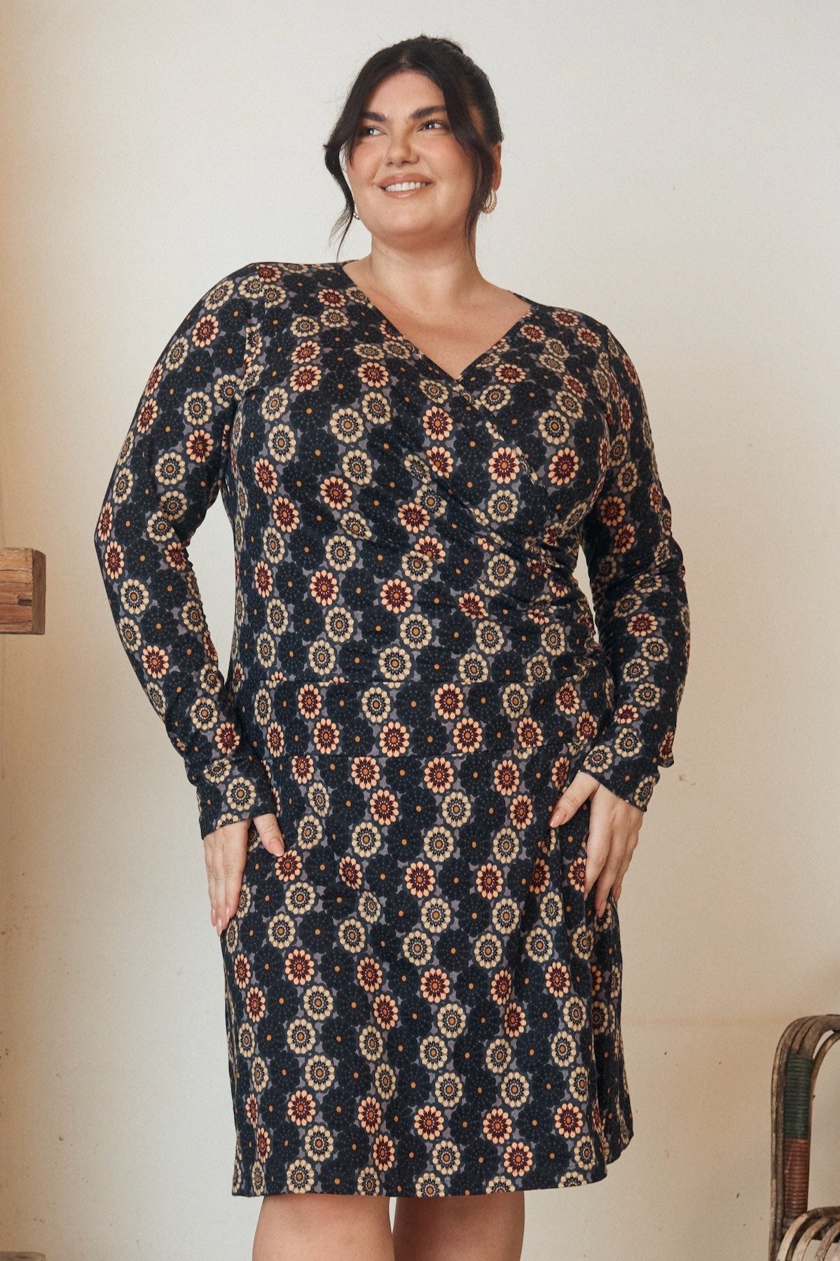 Floral printed dress with a flowing hem and fitted bodice, displayed on a mannequin.