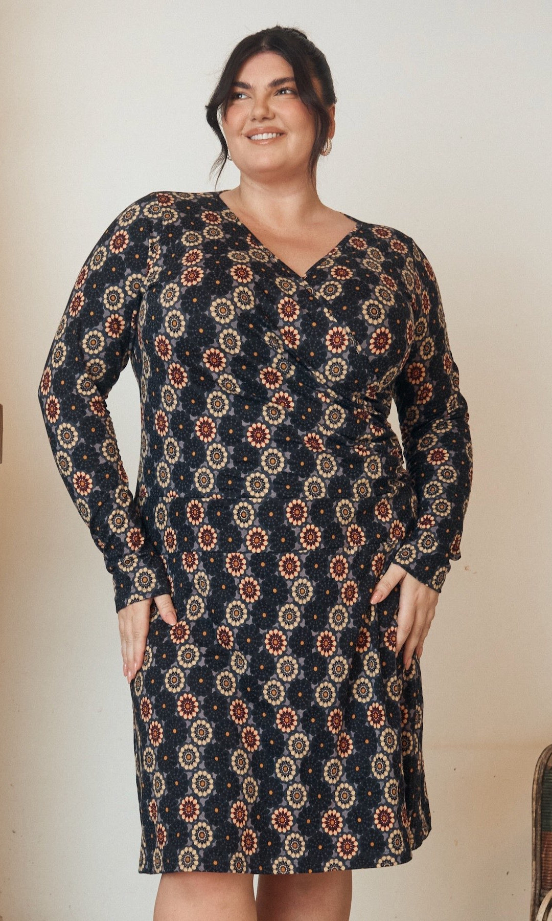 Floral printed dress with a flowing hem and fitted bodice, displayed on a mannequin.