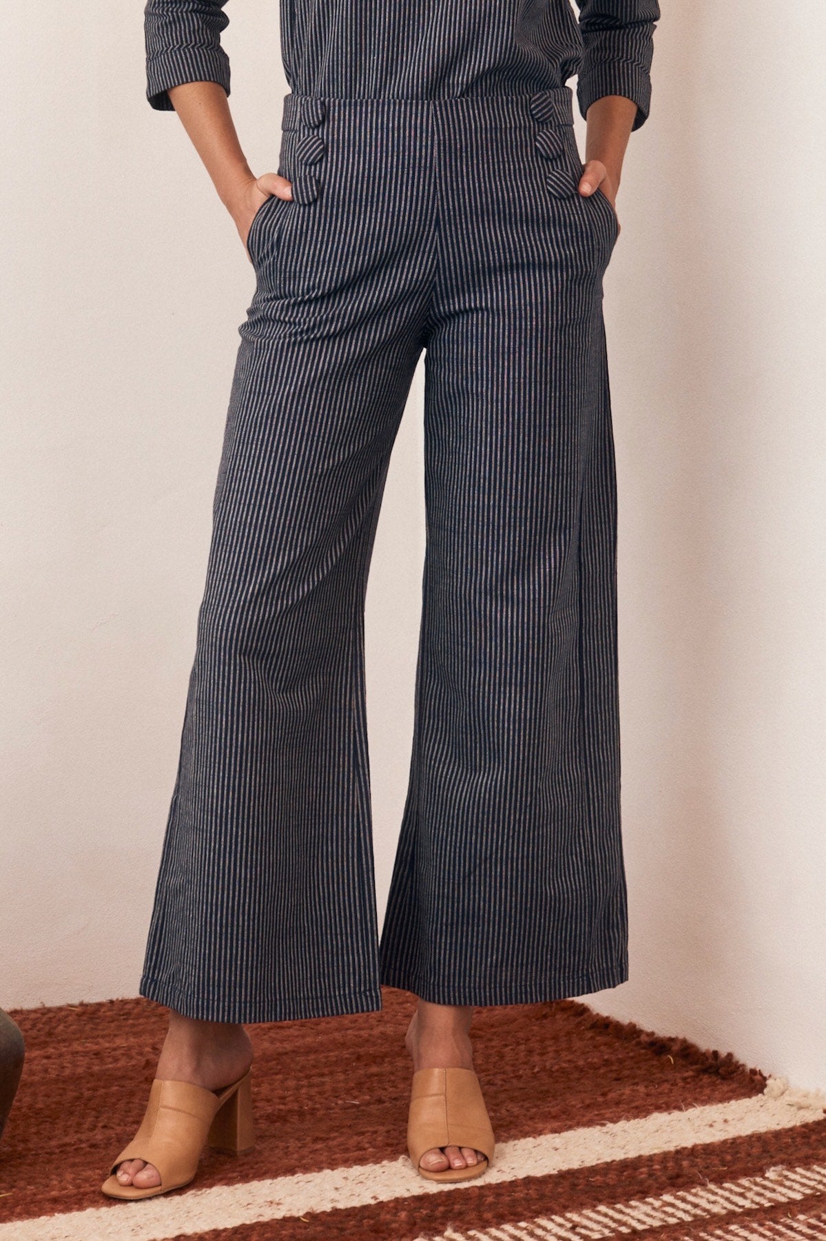 Woman wearing a sleeveless floral dress with a relaxed fit.