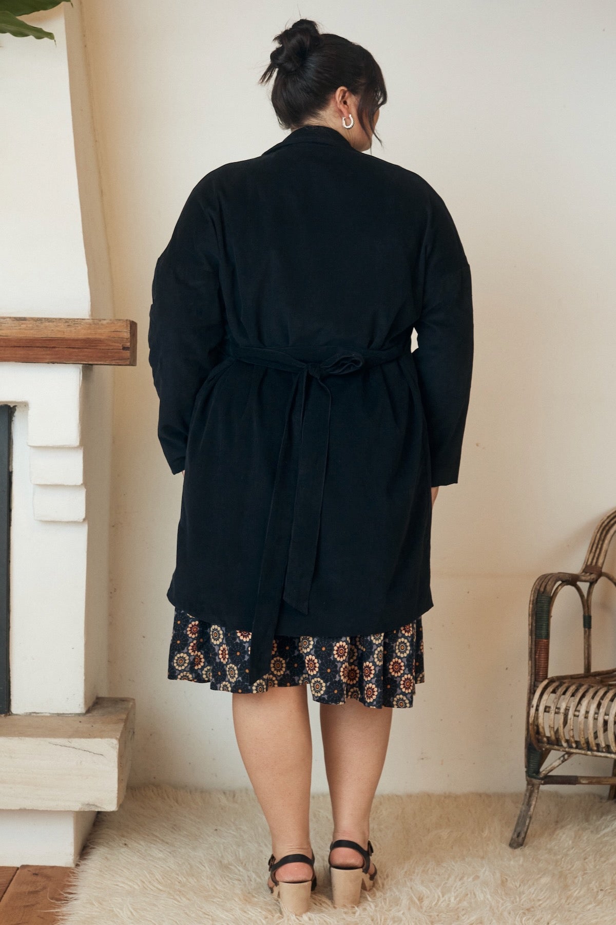 A piece of clothing laid flat, showcasing the gentle drape and delicate texture of the natural fabric.