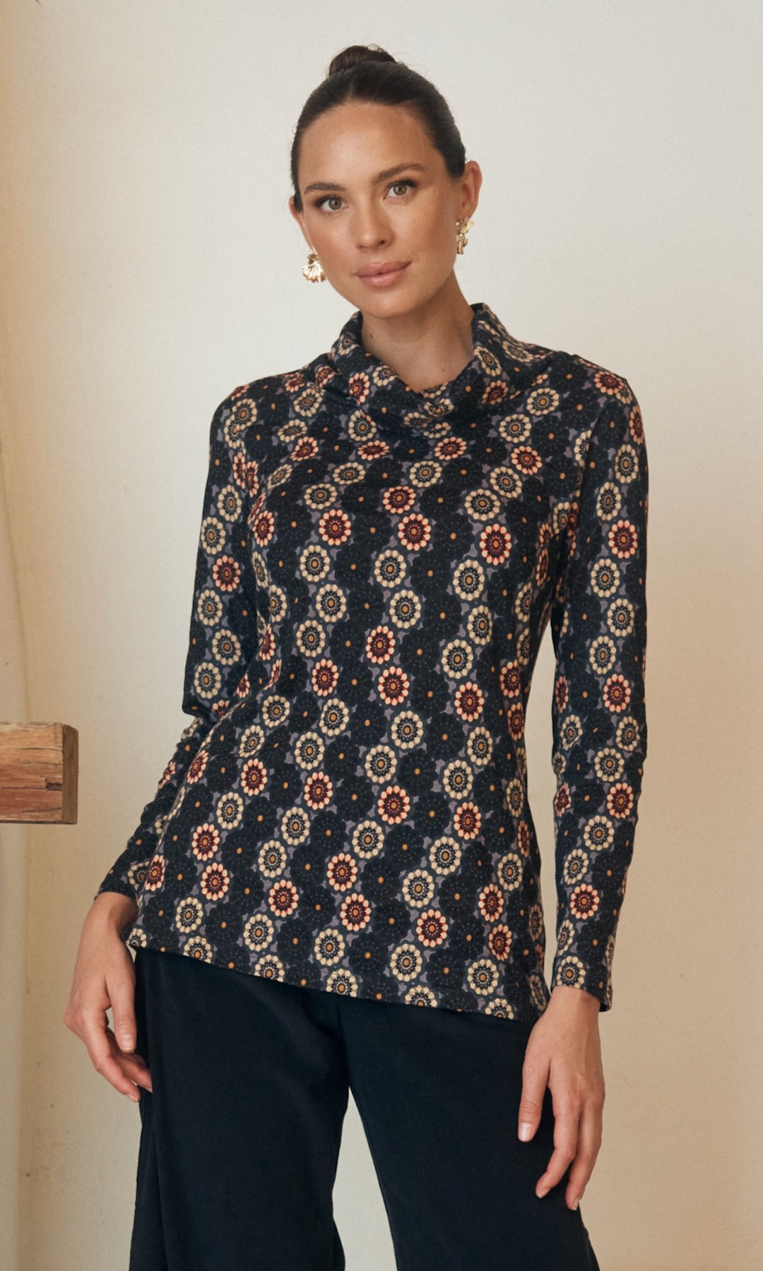 Close-up of a floral dress with intricate button detailing on the bodice.