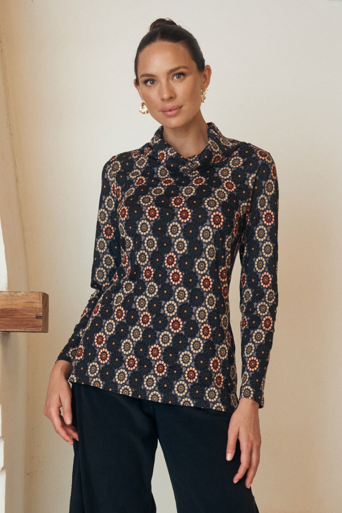 Close-up of a floral dress with intricate button detailing on the bodice.