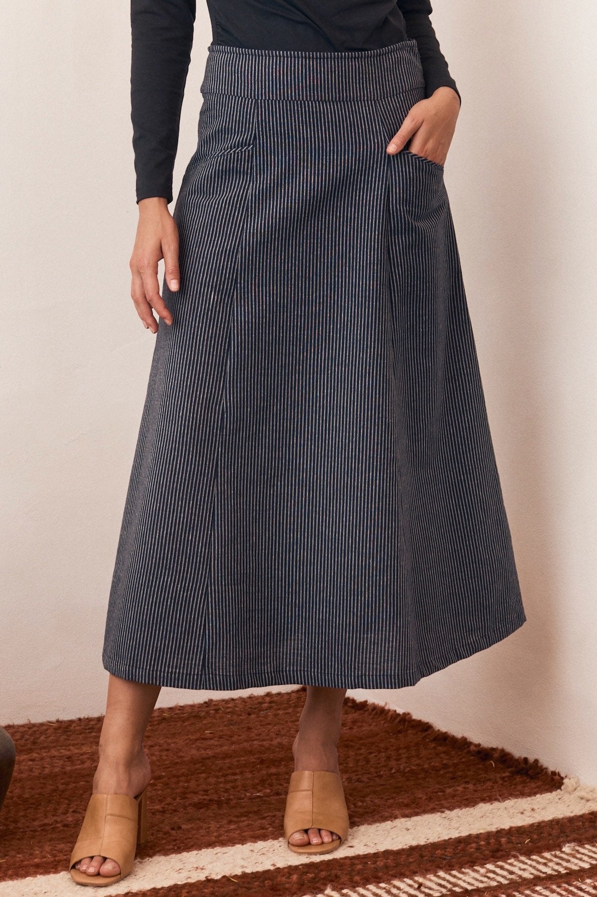 Woman wearing a relaxed-fit dress with a bright floral print.