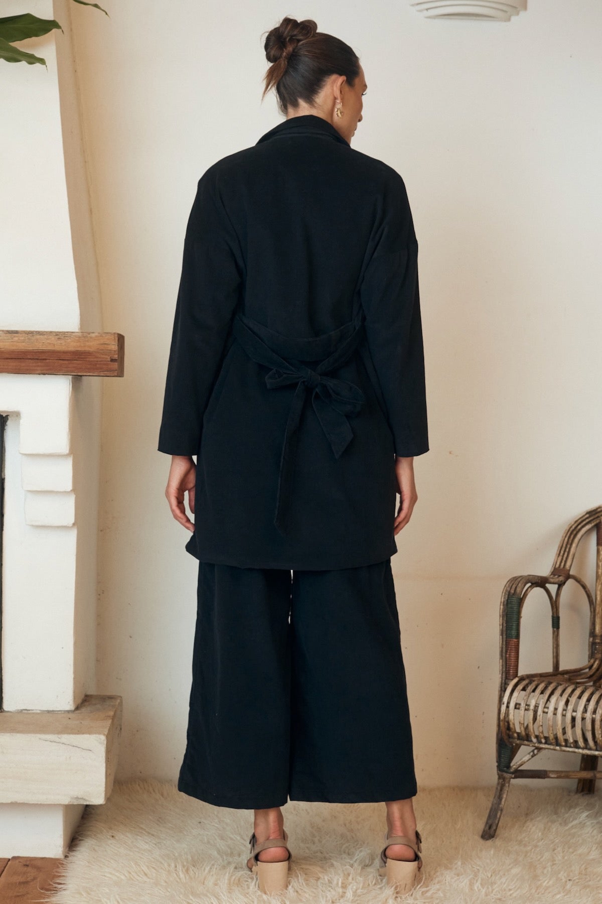 A breezy, bohemian-style dress elegantly displayed, with the fabric’s intricate patterns standing out beautifully.