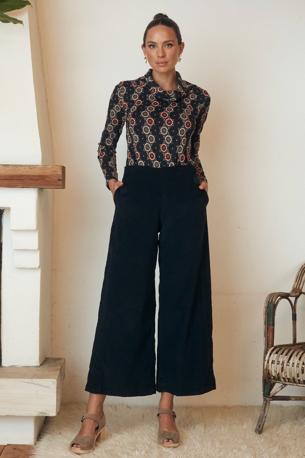 Sleeveless floral dress with a subtle v-neck, displayed on a model.