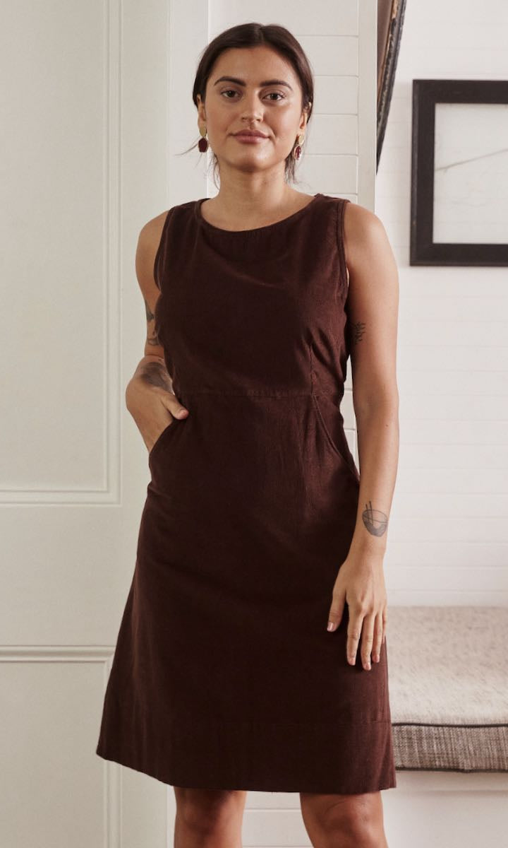 A soft, flowing dress in a natural hue, with the gentle light enhancing the texture and simplicity of the design.