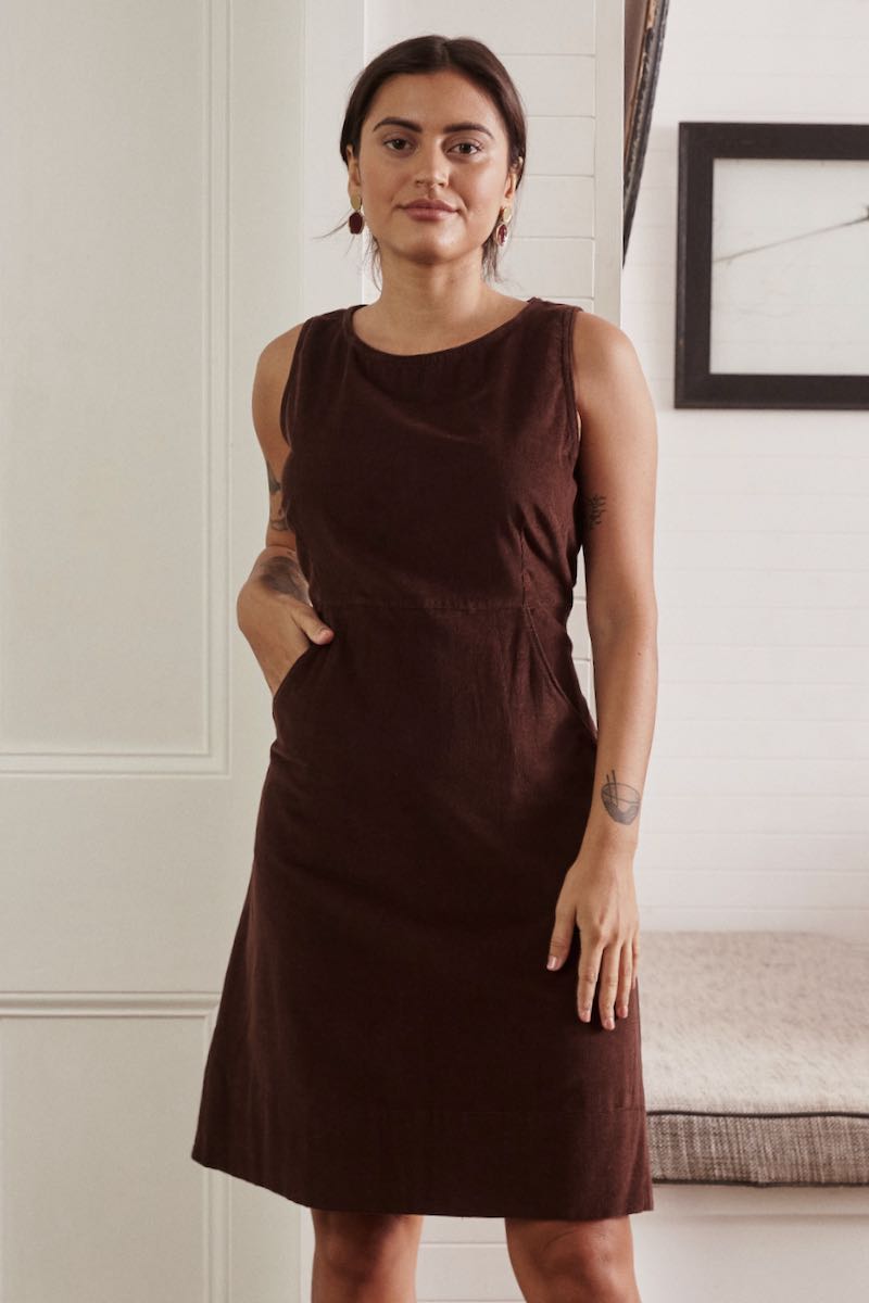 A soft, flowing dress in a natural hue, with the gentle light enhancing the texture and simplicity of the design.