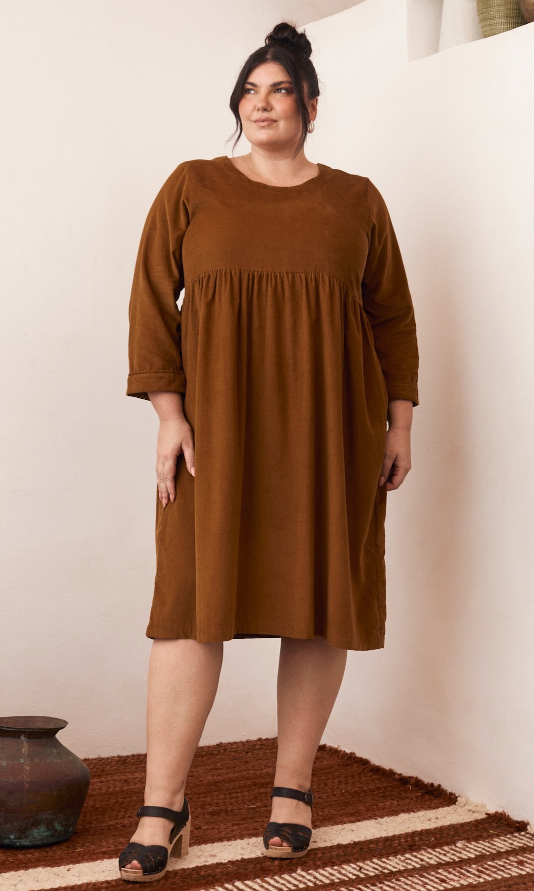 A minimalist dress with clean lines, its simple elegance standing out in a soft, natural light.