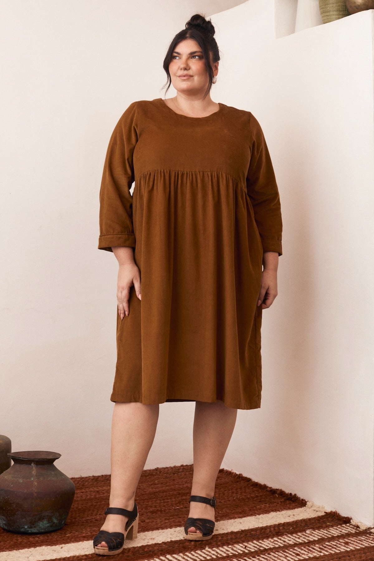 A minimalist dress with clean lines, its simple elegance standing out in a soft, natural light.