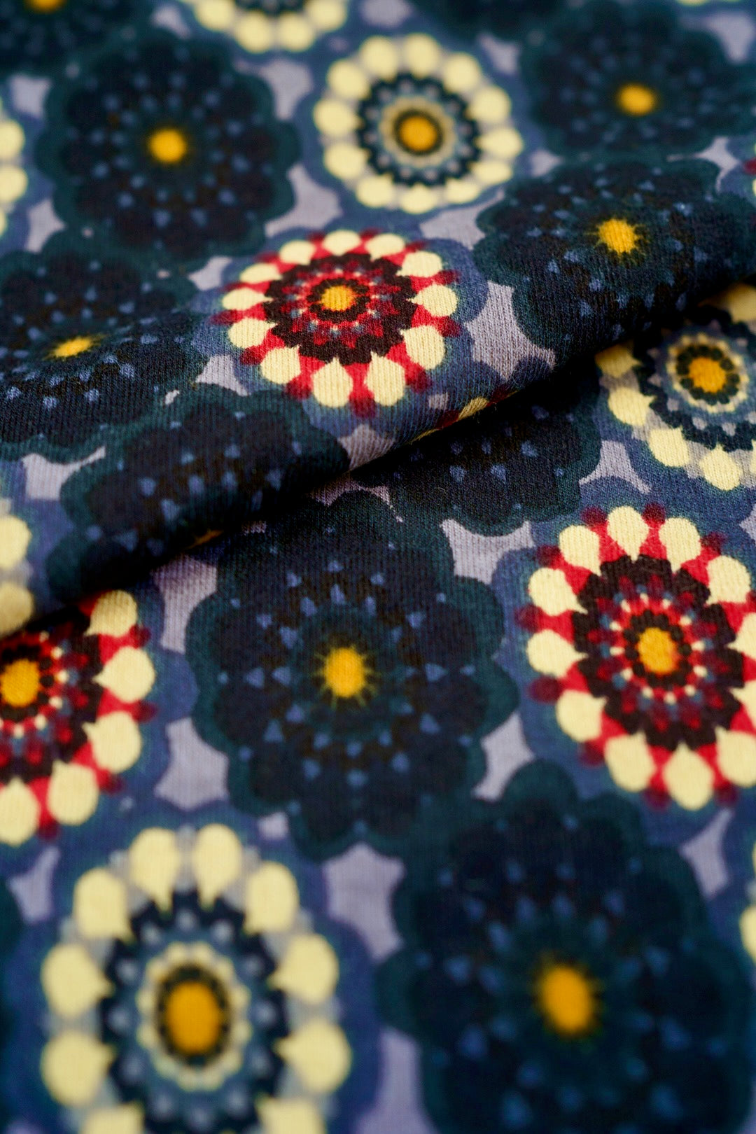 Model wearing a floral print dress, posing against a bright, minimalist backdrop.