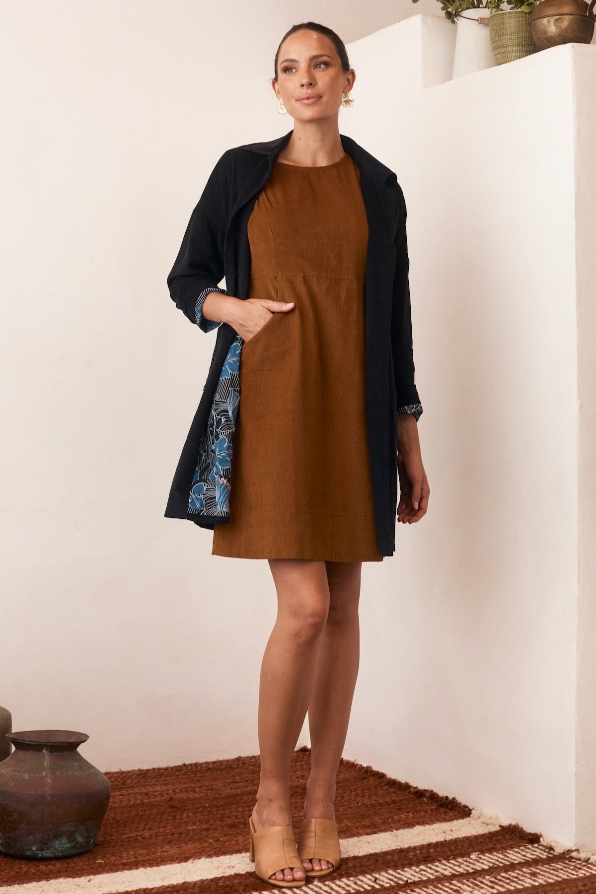 A vibrant, patterned dress, showcasing intricate details and a flattering silhouette in rich, natural hues.