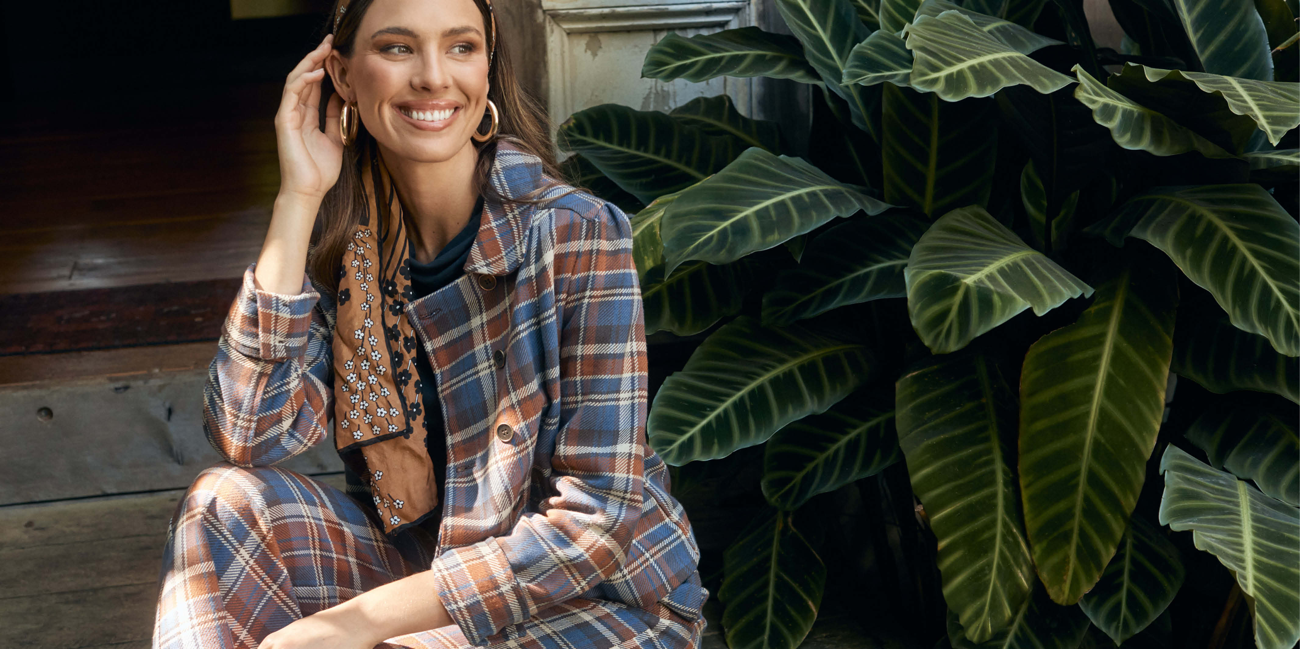 Tartan print dress on a mannequin, with bright colors and a fitted waist.